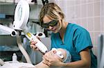 Woman undergoing laser skin treatment or photorejuvenation of the skin on her face in a beauty salon or skin clinic