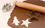 Making gingerbread cookies with cutter and wooden rolling pin