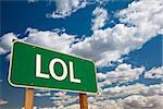 LOL, Texting Abbreviation for Laughing Out Loud, Green Road Sign with Dramatic Sky and Clouds.