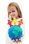 A world of harmony concept with little girl holding earth globe and people made of clay