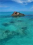 One end of a ship wreck (the Vixen) coming out of a tropical Sea - Portrait