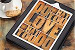 do what you love, love what you do - motivational word abstract in vintage letterpress wood type on a digital tablet