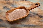 whole grain teff flour from an ancient North African cereal grass, popular in Ethiopian cuisine - a rustic scoop on wood background