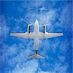 Bottom view - twin prop cargo plane on sky background