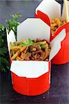 Chinese noodles with vegetables and meat in cardboard box