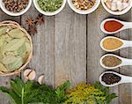 Colorful herbs and spices selection. Aromatic ingredients on wood table with copyspace