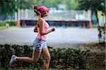 Attractive young girl running in park
