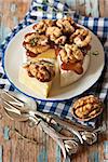 Baked Camembert with walnuts and dark honey on a plate.