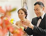 Traditional Chinese wedding tea ceremony, bride and groom, focus on hand and teacup.
