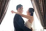 Romantic Asian Chinese wedding couple. Bride and groom dancing on wedding day.