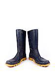 Pair of dark blue dirty rubber boots over a white background