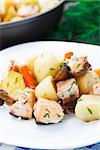 Delicious baked salmon with potato, mushrooms and carrot
