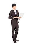 young businessman standing with laptop