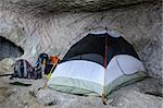Camp, backpacks and one tent in the cave