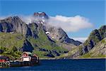 Picturesque mountain peaks towering above fjord on Lofoten islands in Norway