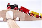 wooden toy train on bridge in grey background. horizontal image