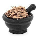 Stellaria root chinese herbal medicine in a black stone mortar with pestle over white background. Yin chai hu