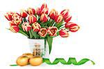 Easter egg group with tulip flower arrangement and ribbon curl over white background.