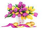Easter eggs with tulip flower arrangement and ribbon curl over white background.