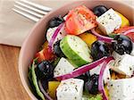 light greek salad, served in bowl with red onion