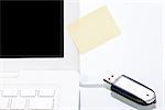 notebook laptop with post it memo and usb stick closeup macro objects office