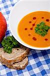 fresh tasty homemade pumpkin soup on wooden table with parsley and bread