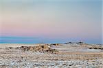 calm winter dusk over prairie in northern Colorado with rock outcropping near Natural Fort geological landmark