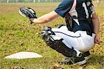 baseball catcher ready to catch ball at  home plate