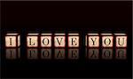 3d wooden cubes over black with letters makes text I love you, retro concept