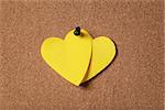 yellow heart shape sticky notes on cork board