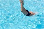 Activities on the pool. Boy diving in swimming pool