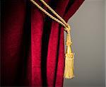 Red velvet curtain with tassel. Close up