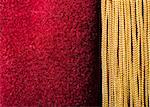 Red velvet curtain with tassel. Close up