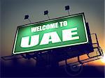 Welcome to UAE - Green Billboard on the Rising Sun Background.