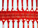 Red Plastic Forks Arranged Touching Ends