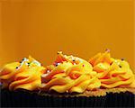 Trio Of Orange Iced Cupcakes In A Row