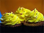 Trio Of Yellow Iced Cupcakes In A Row