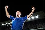 Soccer player cheering in stadium