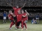 Soccer players cheering on field