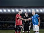 Soccer players shaking hands on field