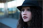 Close-up portrait of teenage girl outdoors, wearing fedora, Germany