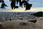 Scenic overview of the city of Athens with stones from the Acropolis in the foreground, Aegean sea in background, Athens, Greece