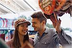 Close-up of young couple having fun at amusement park, Germany