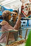 Young couple having fun at amusement park, Germany