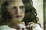 Close-up portrait of teenage girl looking out window, Germany