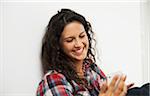 Close-up portrait of teenage girl looking at cell phone and smiling, Germany