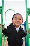 Close-up portrait of smiling little boy at playground, USA