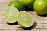 green fresh lime on wooden table macro closeup outdoor summer
