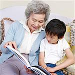 grandma and grandson reading a book together.