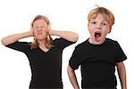 Screaming young boy and girl covering her ears